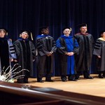 Faculty members wait to be honored on stage